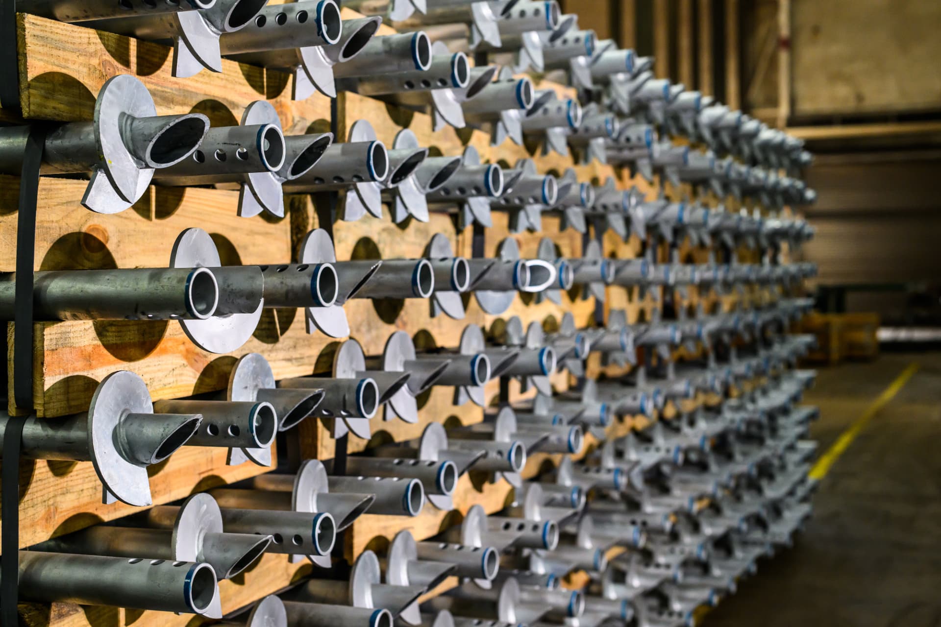 Finished steel shaft assemblies stored on manufacturing racks