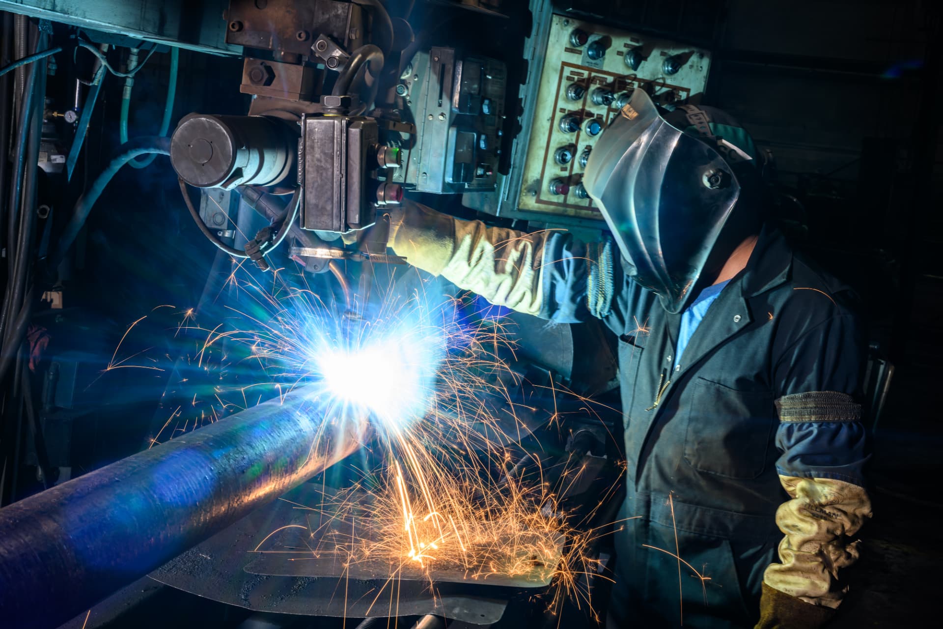 Welder joining steel shaft components at the Helical Anchors manufacturing facility.