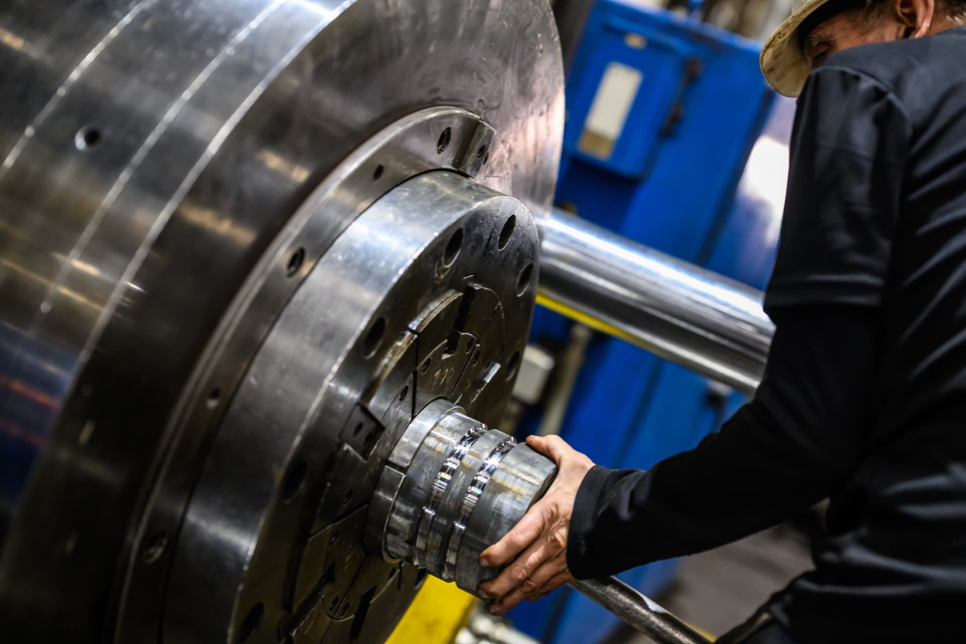 Operator setting up a shaft coupler in the manufacturing machine