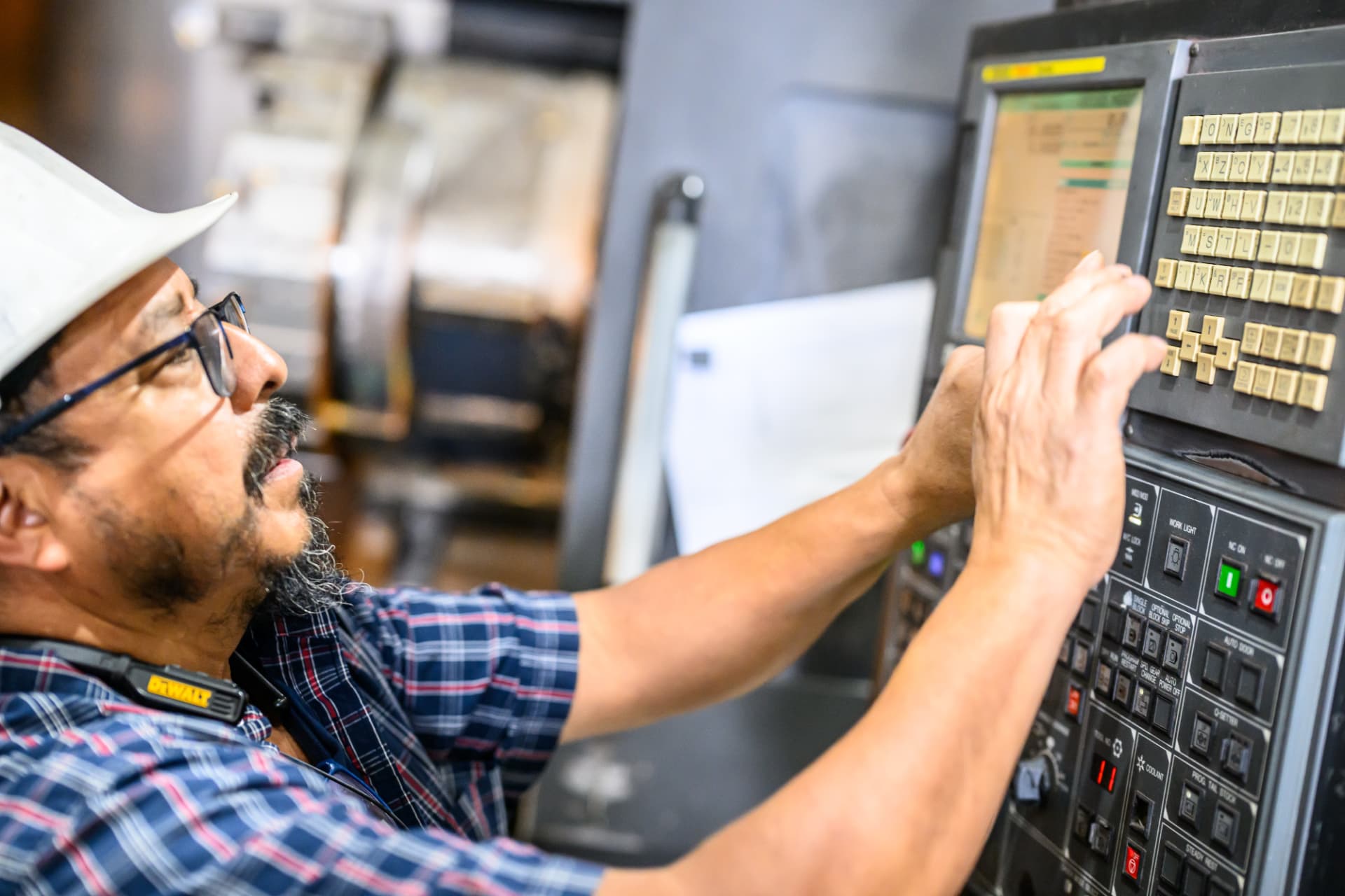 Operator programming a CNC machine for pile components